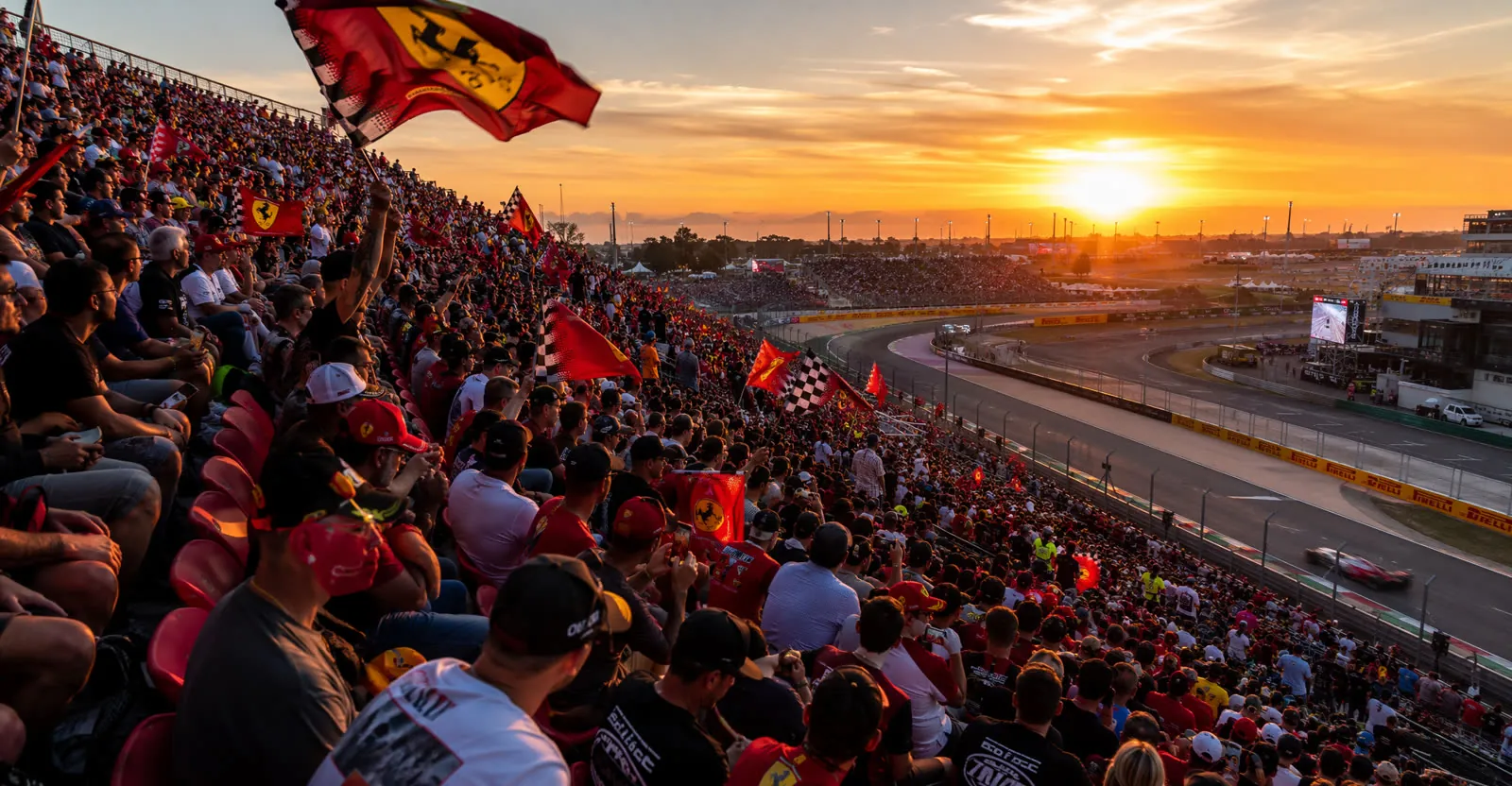Packed grandstand of Formula 1 fans at sunset