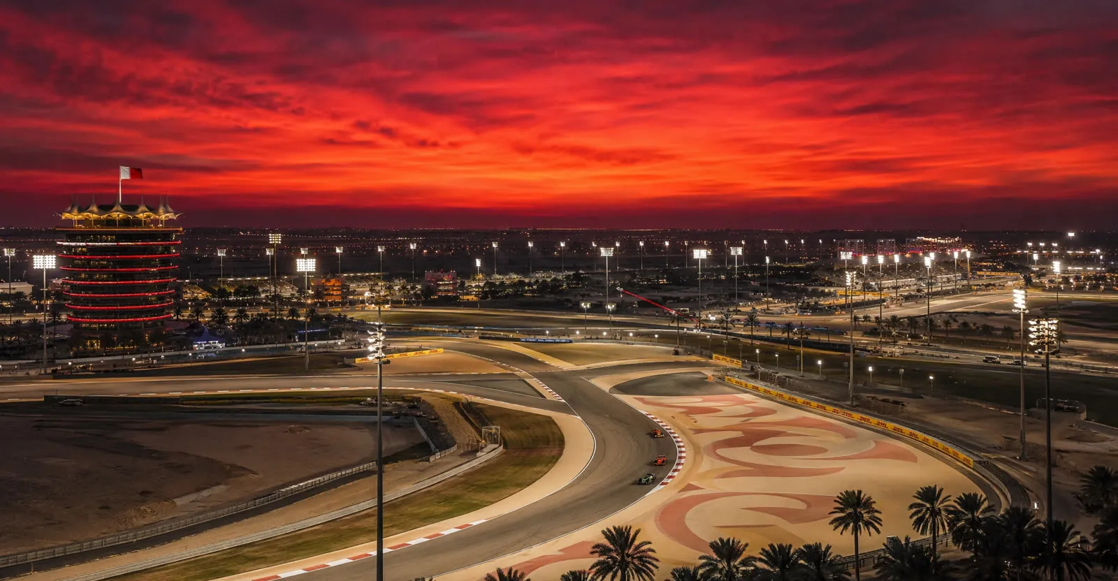 Bahrain International Circuit at dusk with red desert sky
